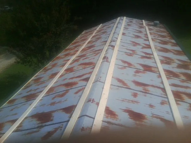 Rusted metal roof panels with new wood purlins before replacement — Storm Damage Roof Repair in Porter Ranch by Roofing Brothers