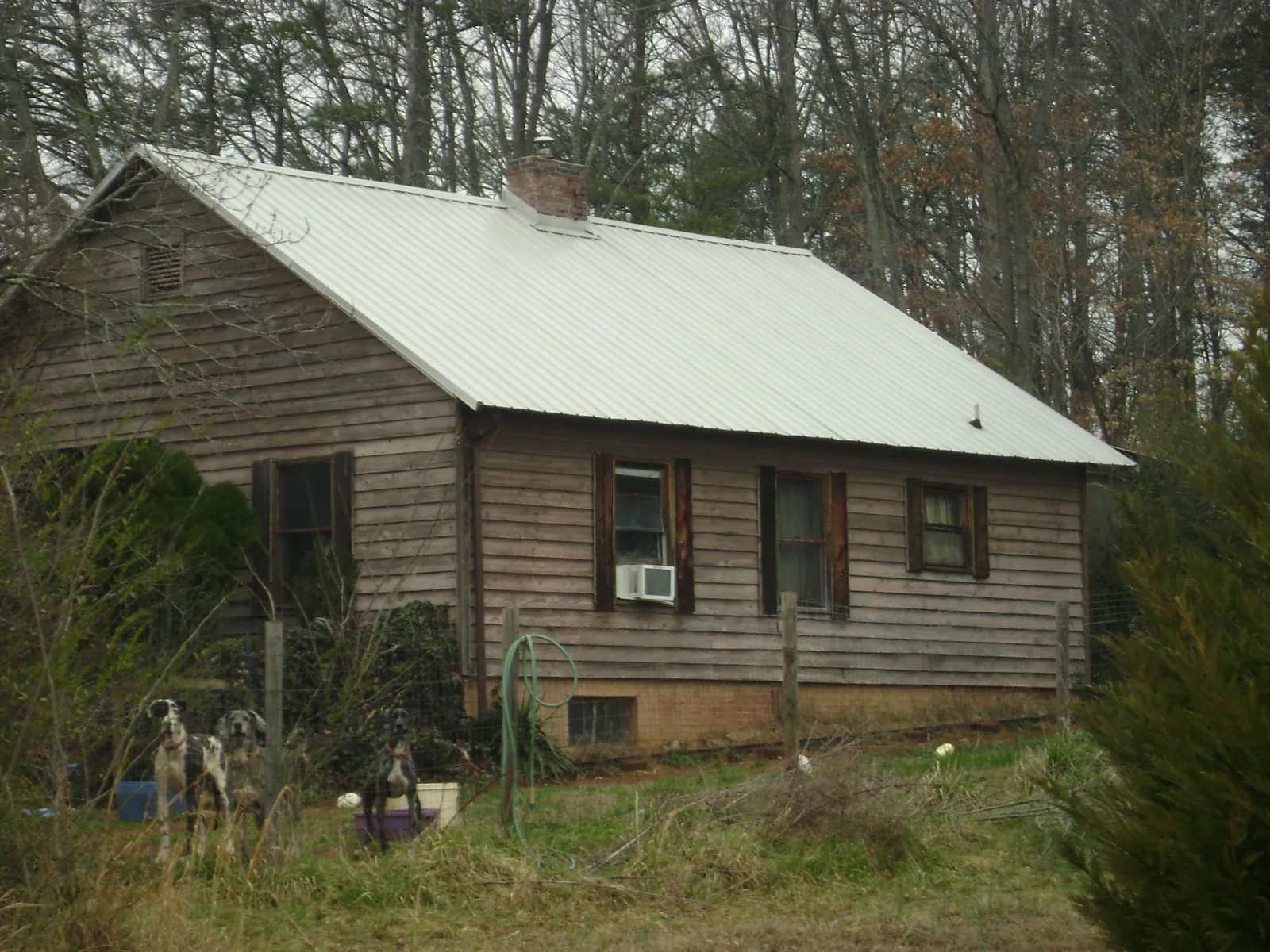 White metal roof on an old wood sided farmhouse, from a Metal Roof Installation job in Porter Ranch